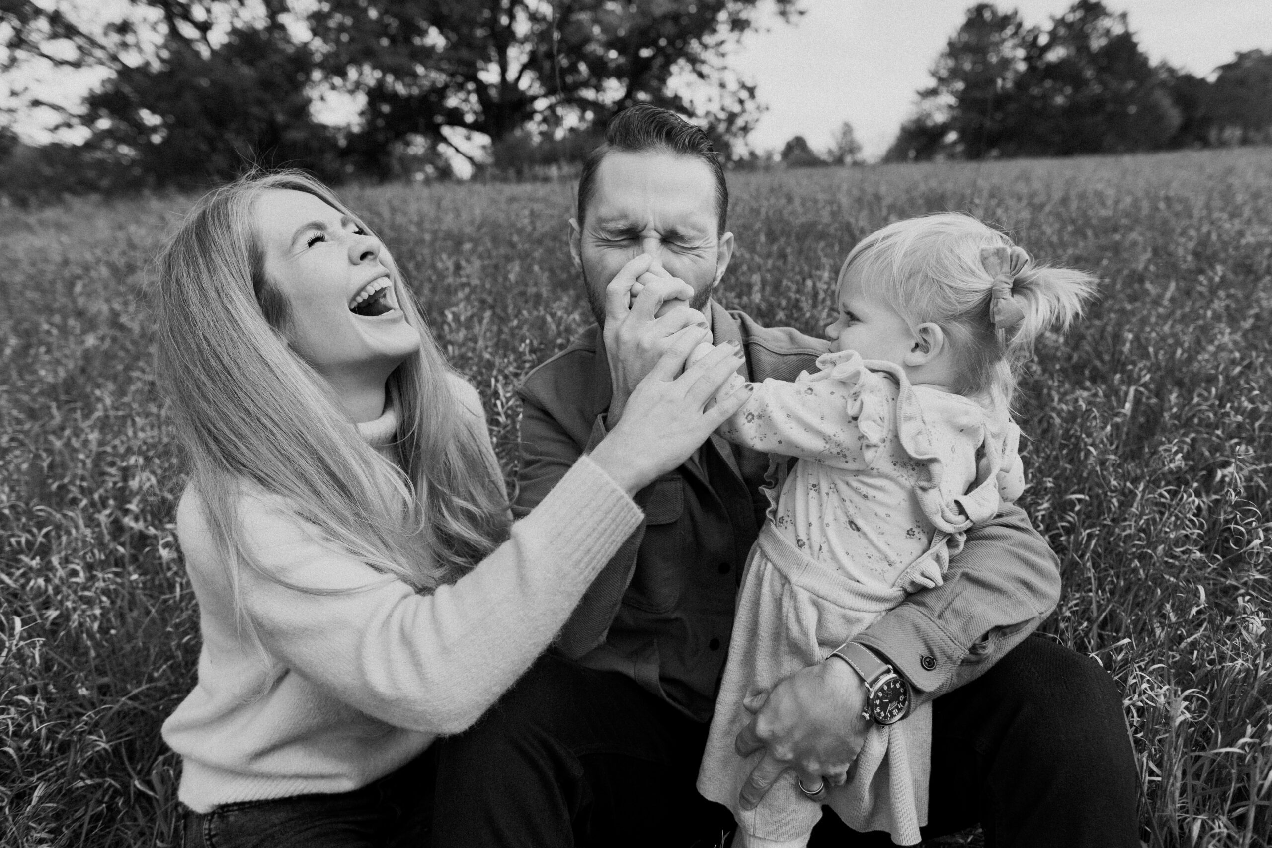 Husband and wife photography team in Ann Arbor, Michigan with their daughter